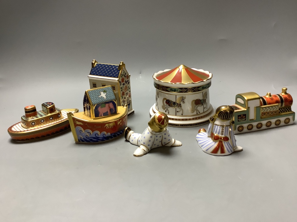 A Royal Crown Derby Treasures of Childhood Carousel money box and six other Royal Crown Derby models and paperweights